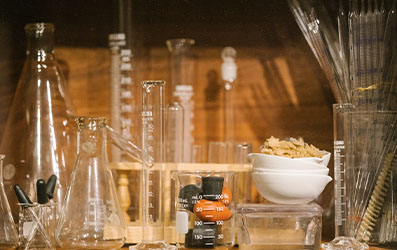 Wooden shelf with lab glassware.